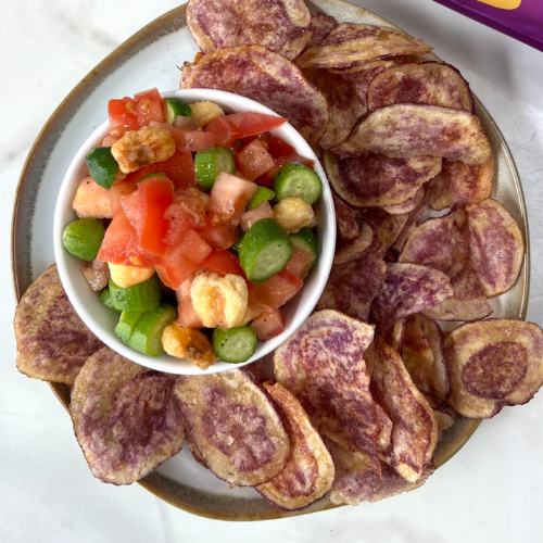 Bowl of crunchy salsa made with diced tomato, cucumber and Giant Peruvian Inca Crunchy Corn, served with chips