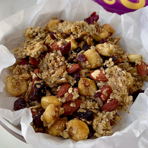 Bowl of savory granola with almonds, craisins and Giant Peruvian Inca Crunchy Corn